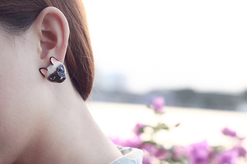 Handmade jewelry showcasing Siamese cat earrings on a model.