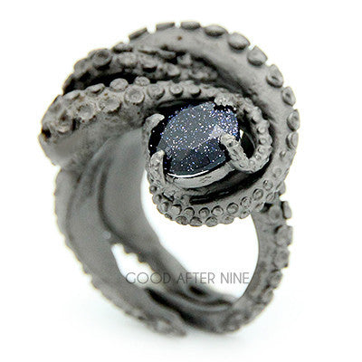 Unique octopus ring featuring a dark gemstone in the center, showcasing intricate tentacle details.