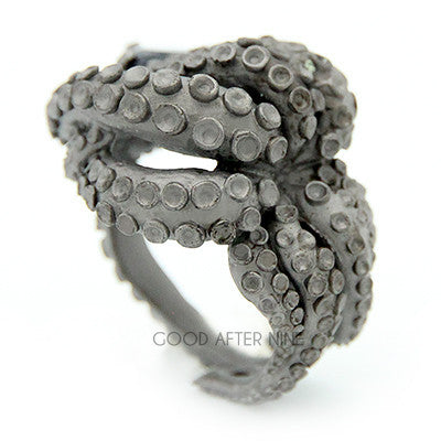 Beautifully crafted octopus ring featuring a dark gemstone in the center, showcasing intricate tentacle details.