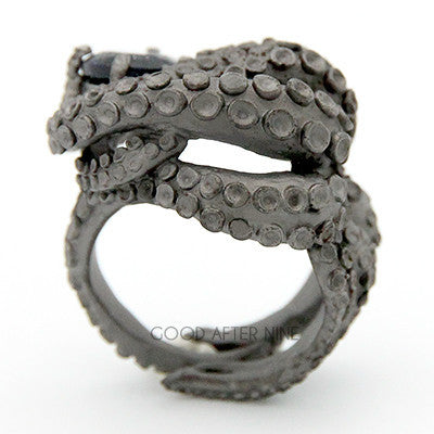 A octopus ring featuring a dark gemstone in the center, perfect for unique jewelry lovers.