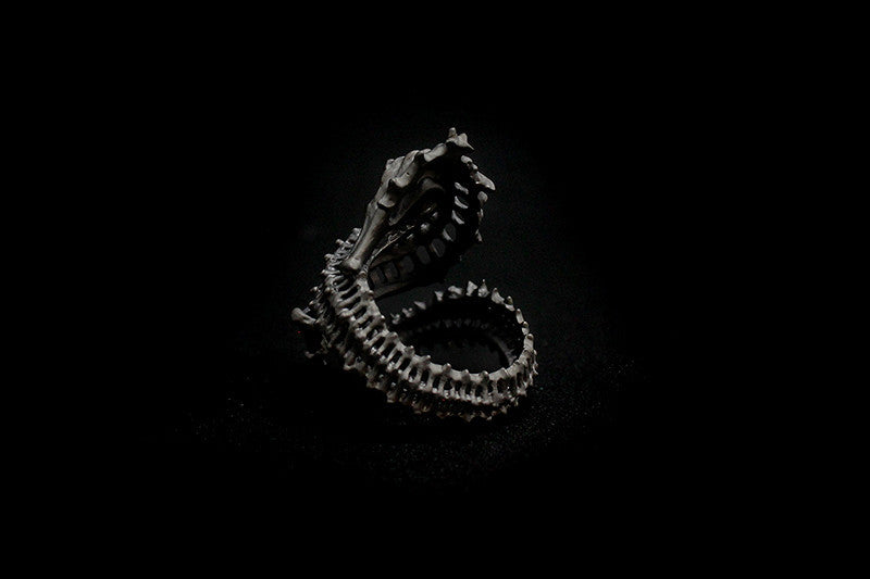Artisan ring with a reef-inspired seahorse skeleton design and a purple gemstone.