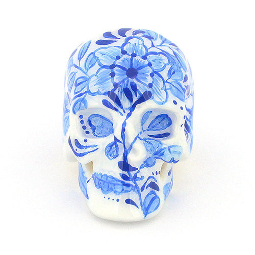 Hand-painted skull ring with artistic blue floral artwork.