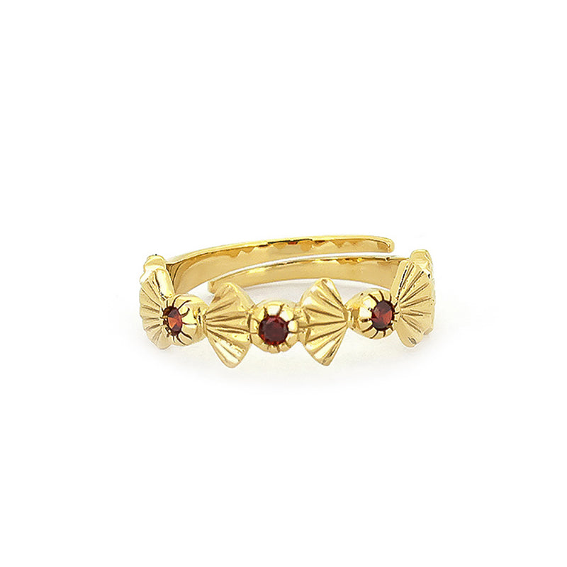 Artisan-crafted gold ring featuring garnet stones and intricate design