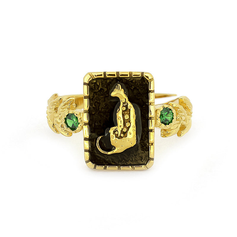Elegant golden ring featuring a leopard design and green gemstones.