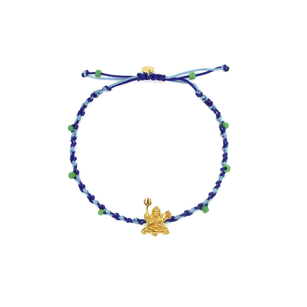 A colorful bracelet in blue threads with blue and green beads, featuring a gold Trimurti Shiva charm
