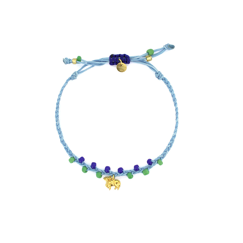 A colorful bracelet in blue threads with blue and green beads, featuring a gold Nandi charm
