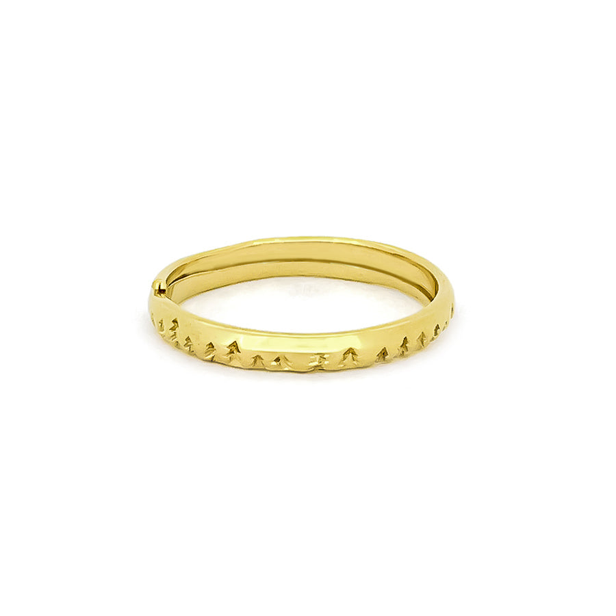 Nature-inspired gold stacking ring featuring a textured design of small trees
