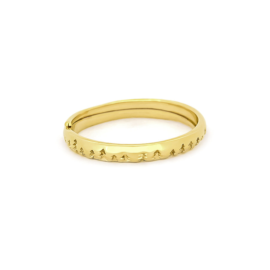 Minimal golden ring featuring a textured design of trees
