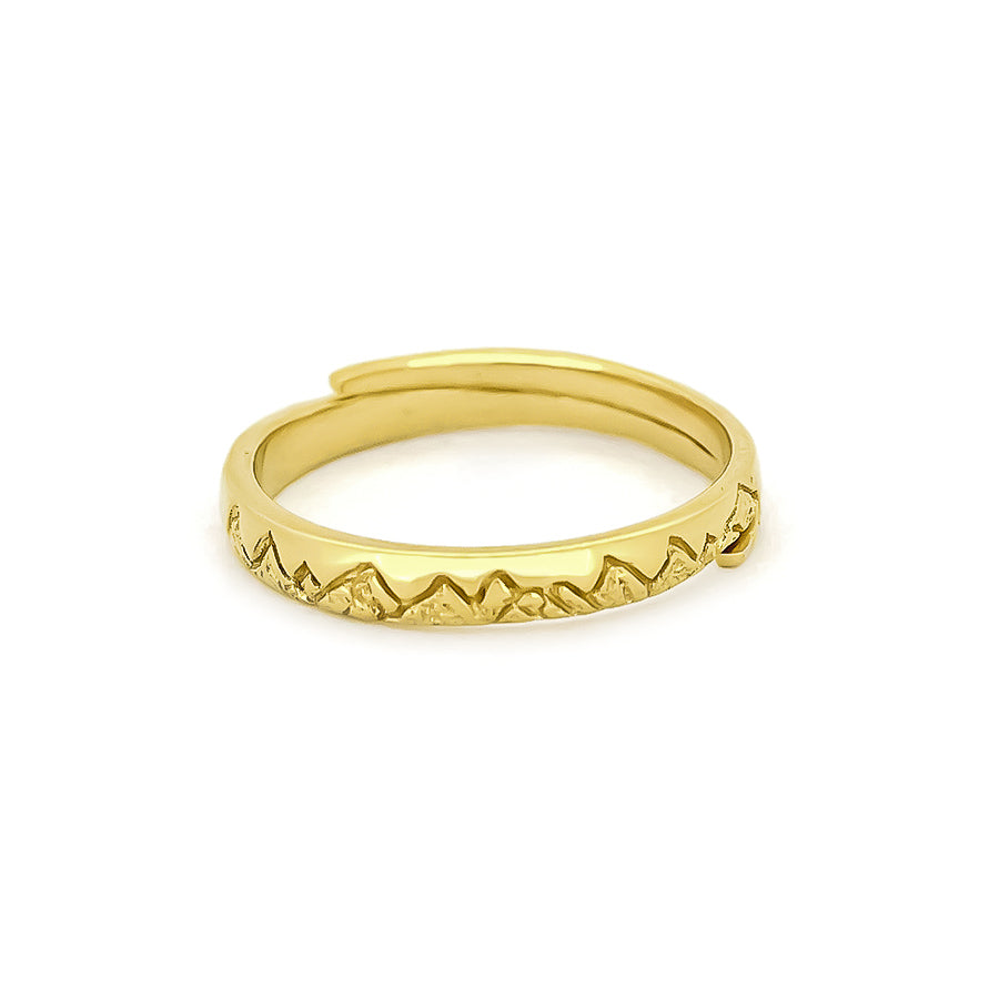 Nature-inspired gold ring with a jagged mountain design around the band.